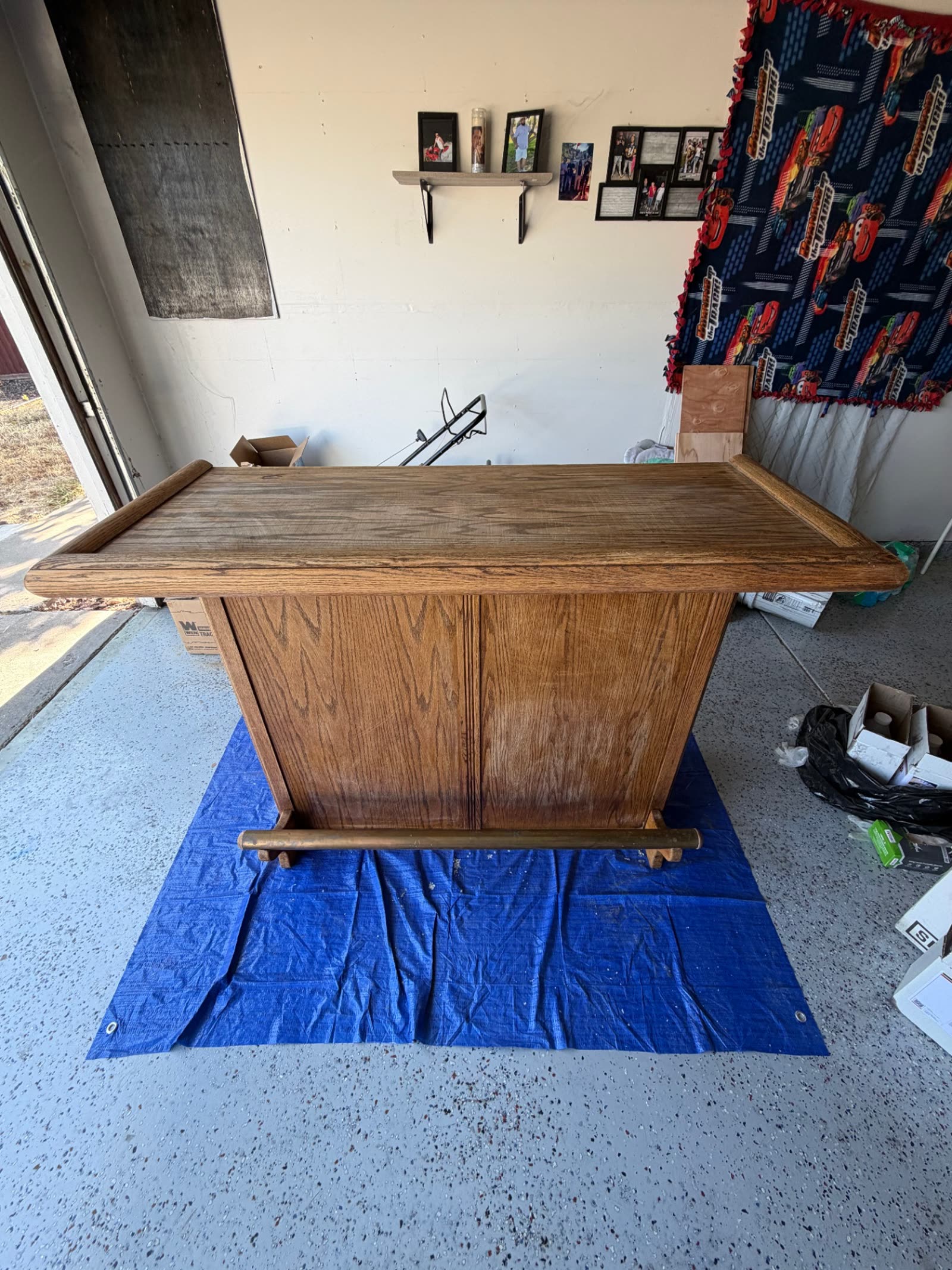 Worn oak home bar in a garage before epoxy resin refinishing